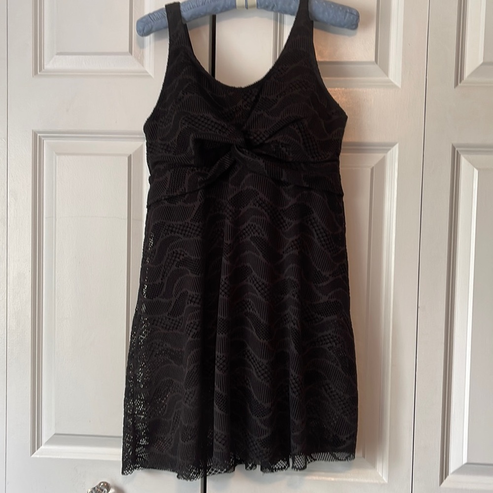 Women’s size large (14/16) bathing suit. Never worn. Full coverage lace overlay